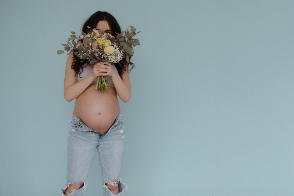 cute maternity photo idea with flowers in rochester ny